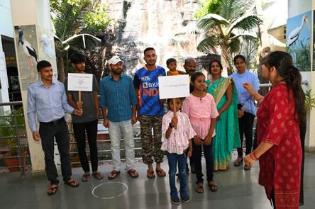 A group of people standing together holding signsDescription automatically generated with medium confidence