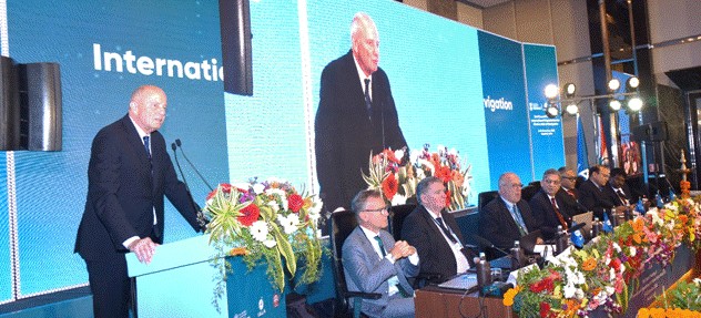 A person standing at a podium with a person in a suit standing at a podiumAI-generated content may be incorrect.