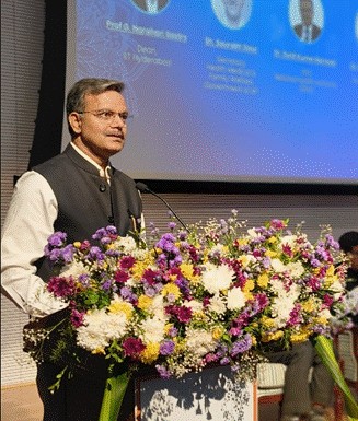 A person standing at a podium with a large bouquet of flowersAI-generated content may be incorrect.