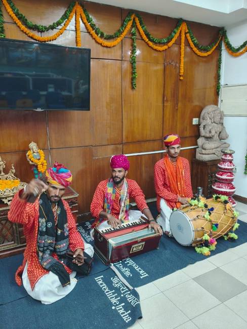 A group of men sitting on the floor playing instrumentsAI-generated content may be incorrect.