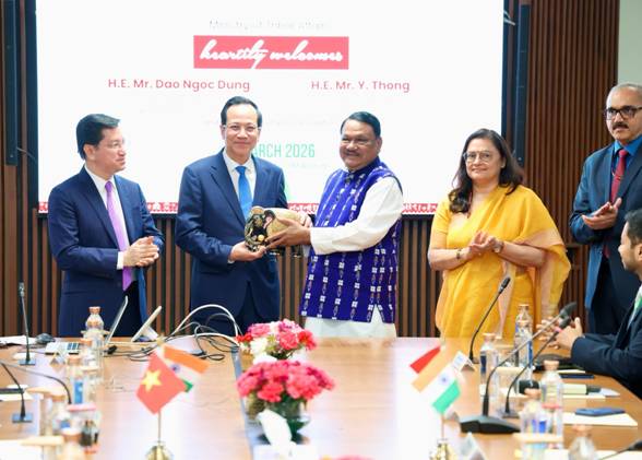 A group of people standing around a tableAI-generated content may be incorrect.