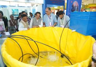 A group of men looking at a yellow objectAI-generated content may be incorrect.