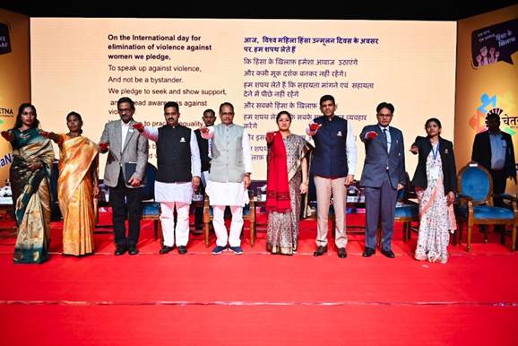 A group of people standing on a red carpetDescription automatically generated