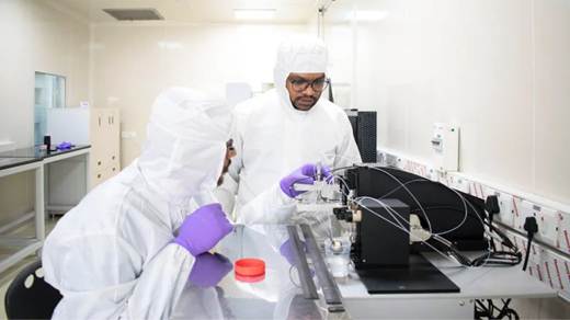 A few people in white protective suits working in a laboratoryAI-generated content may be incorrect.