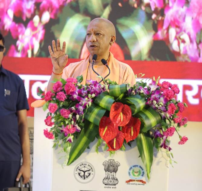 A person speaking at a podium with flowersAI-generated content may be incorrect.