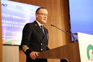 A person in a military uniform standing at a podiumDescription automatically generated