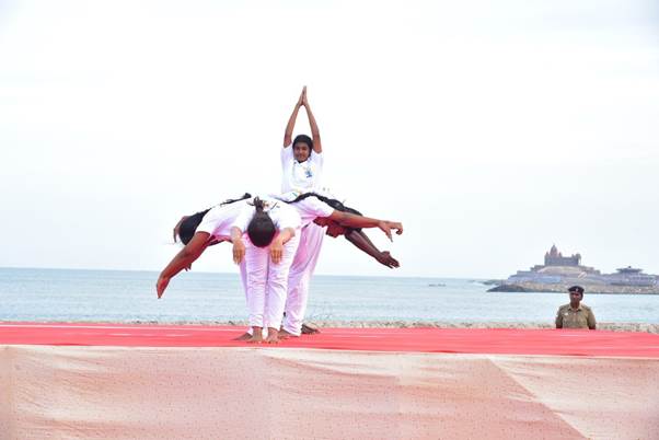 Two people doing martial arts on a beachDescription automatically generated with low confidence