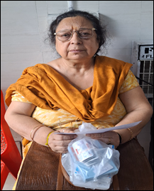 A person sitting on a chair holding a piece of paperDescription automatically generated