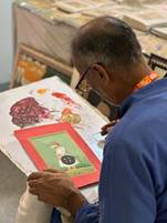 A person painting a pictureAI-generated content may be incorrect.