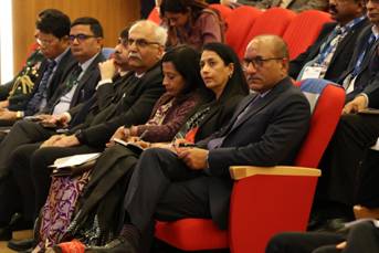 A group of people sitting in a red chairDescription automatically generated