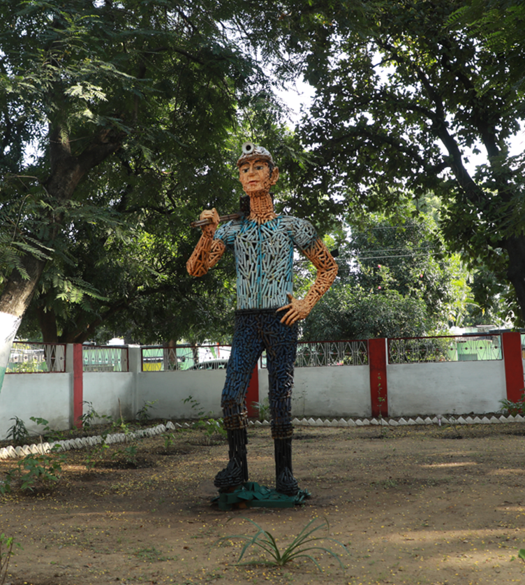 A statue of a person in a parkDescription automatically generated