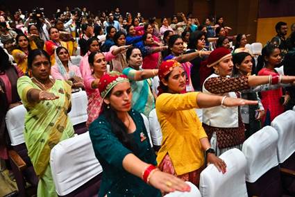 A group of women in colorful clothes doing a danceDescription automatically generated