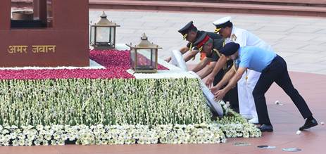 A group of people placing flowers on a tableDescription automatically generated