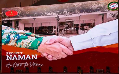 A person in military uniform shaking handsDescription automatically generated