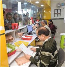 A group of people working at a deskDescription automatically generated