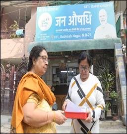 A person holding a red box and a person standing in front of a buildingDescription automatically generated