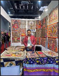 A person standing in front of a table with colorful fabricAI-generated content may be incorrect.