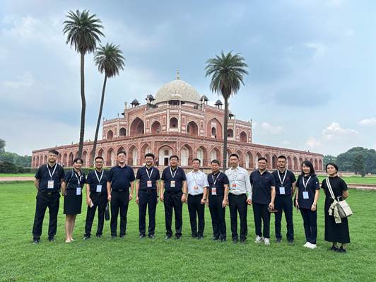 A group of people standing in front of a buildingDescription automatically generated