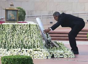 A person in a suit pushing a flowerDescription automatically generated