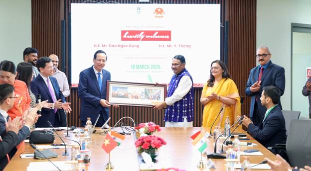 A group of people standing around a tableAI-generated content may be incorrect.