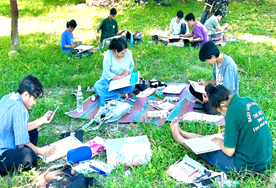 A group of people sitting on the grassAI-generated content may be incorrect.