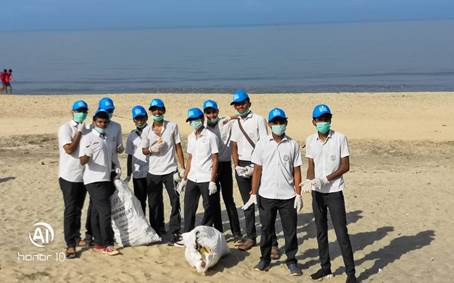 A group of people wearing blue helmets and face masks on a beachDescription automatically generated with low confidence