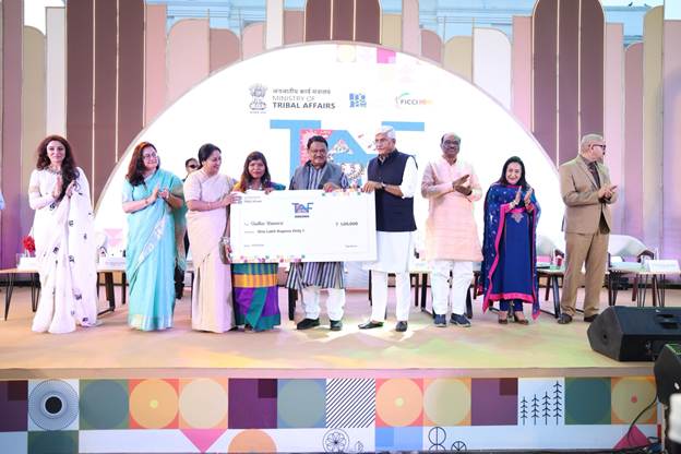 A group of people on a stage holding a large checkAI-generated content may be incorrect.