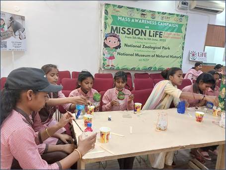 A group of children sitting at a tableDescription automatically generated with medium confidence