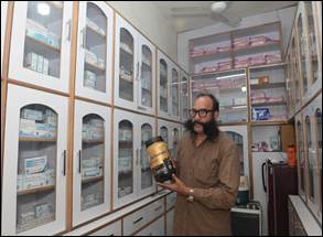 A person with a beard holding a jar of proteinDescription automatically generated
