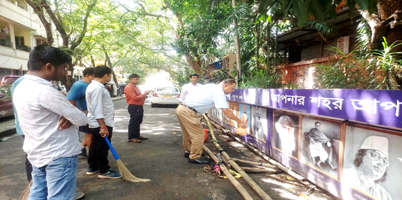 A group of men cleaning a wallAI-generated content may be incorrect.
