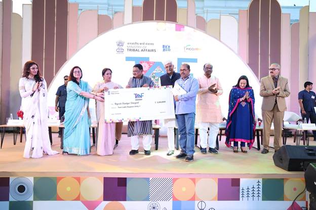 A group of people on a stage holding a large checkAI-generated content may be incorrect.